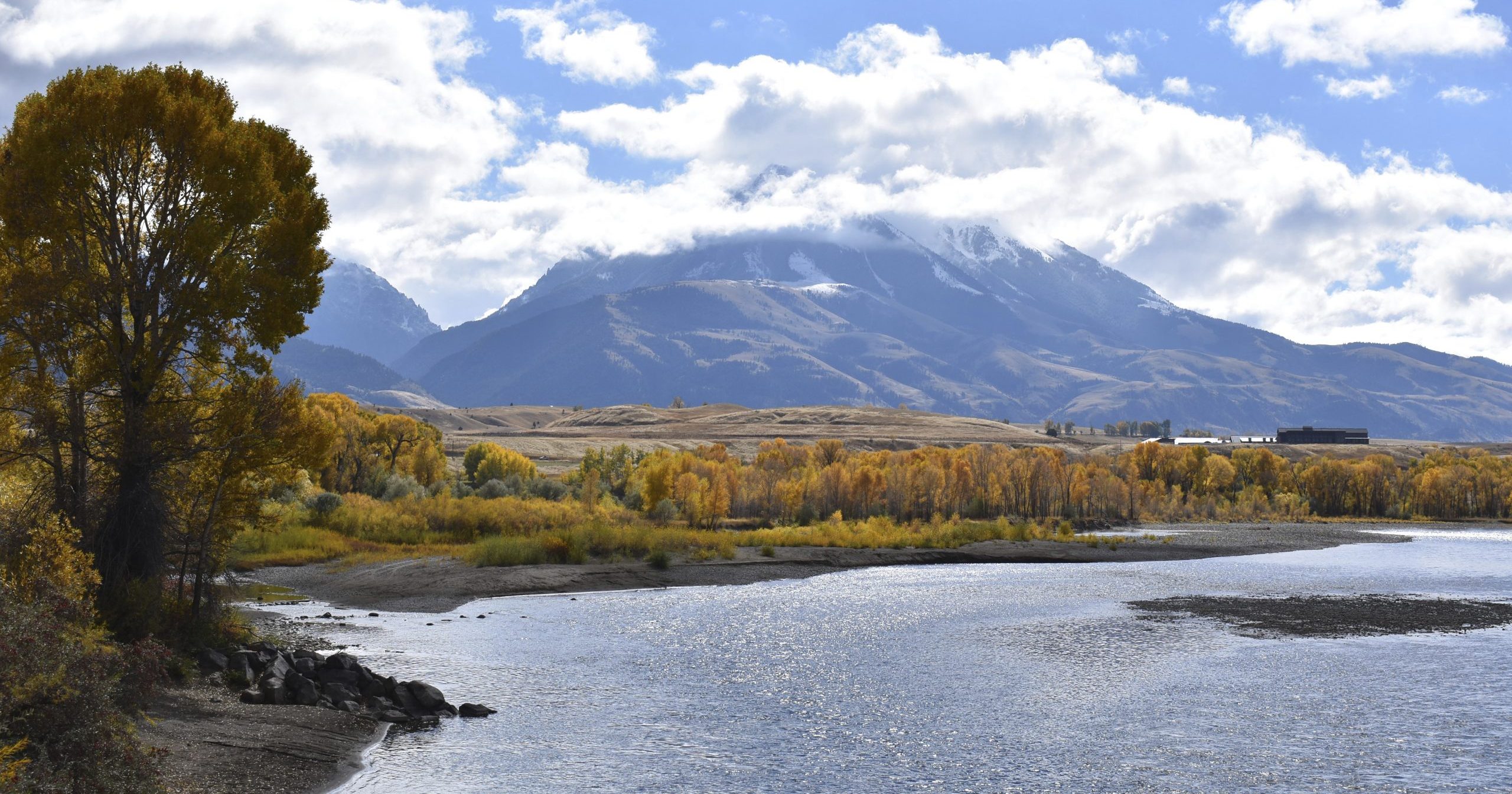 In this Oct. 8, 2018, file photo, Emigrant Peak is seen rising above the Paradise Valley and the Yellowstone River near Emigrant, Montana. Lawmakers have reached bipartisan agreement on a deal to double spending on a popular conservation program and devote nearly $2 billion a year to improve and maintain national parks.