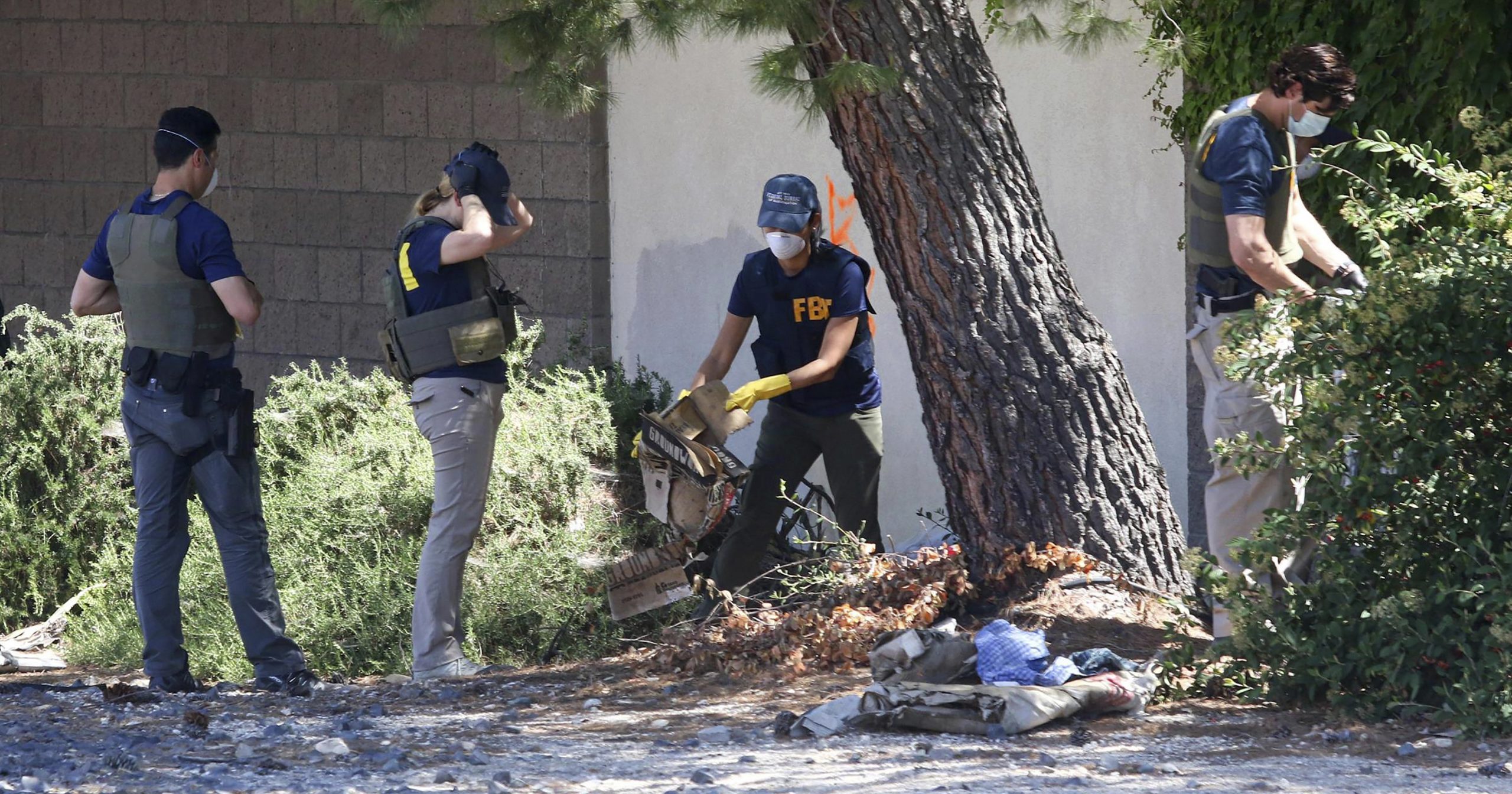 FBI agents examine an area in Paso Robles, California, on June 11, 2020, after the shooting of a sheriff's deputy early Wednesday. The gunman, 26-year-old Mason James Lira, was killed by police in a shootout on Thursday.