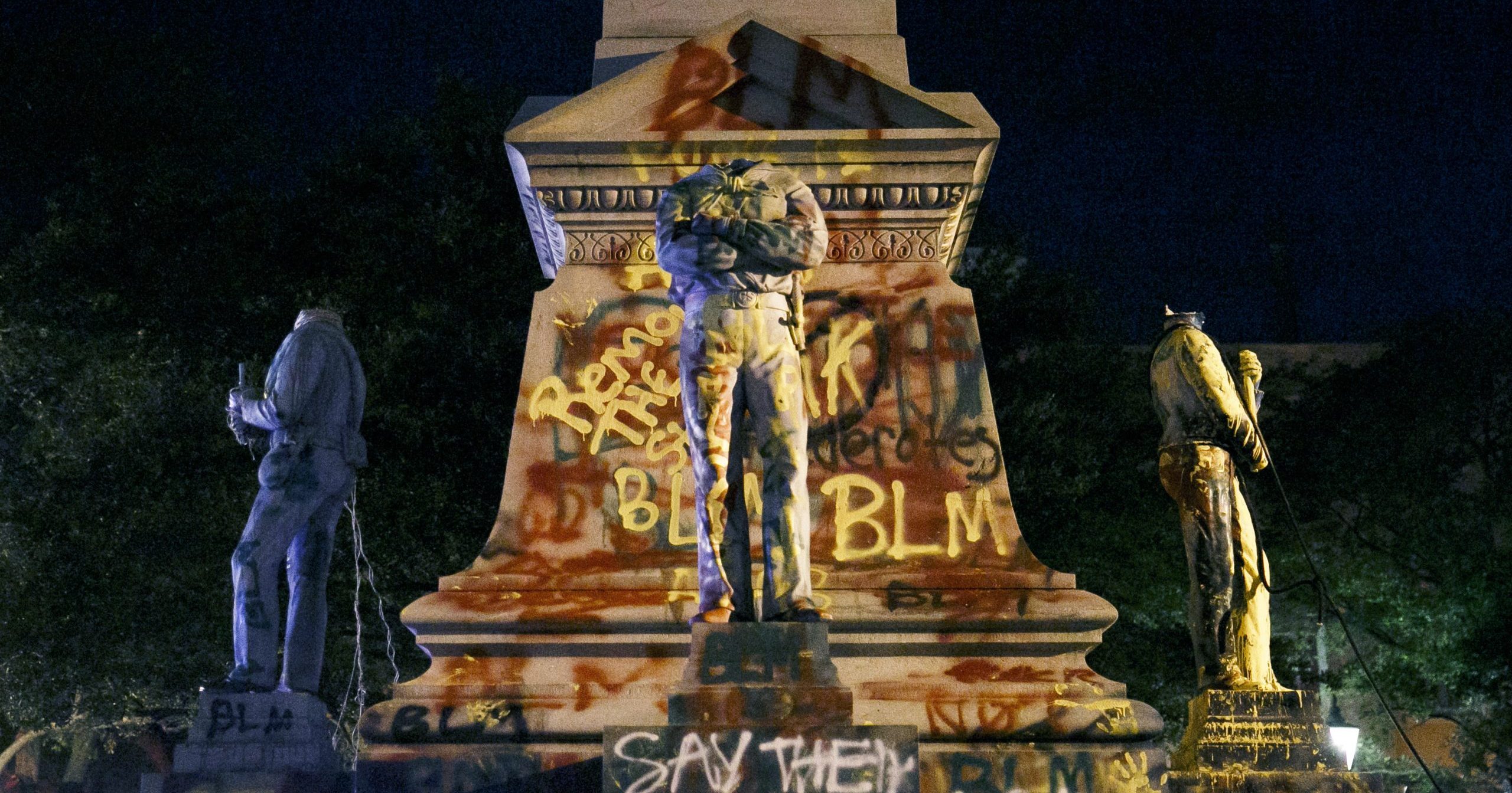 Statues on a Confederate monument are covered in graffiti and beheaded after a protest in Portsmouth, Virginia, on June 10, 2020.