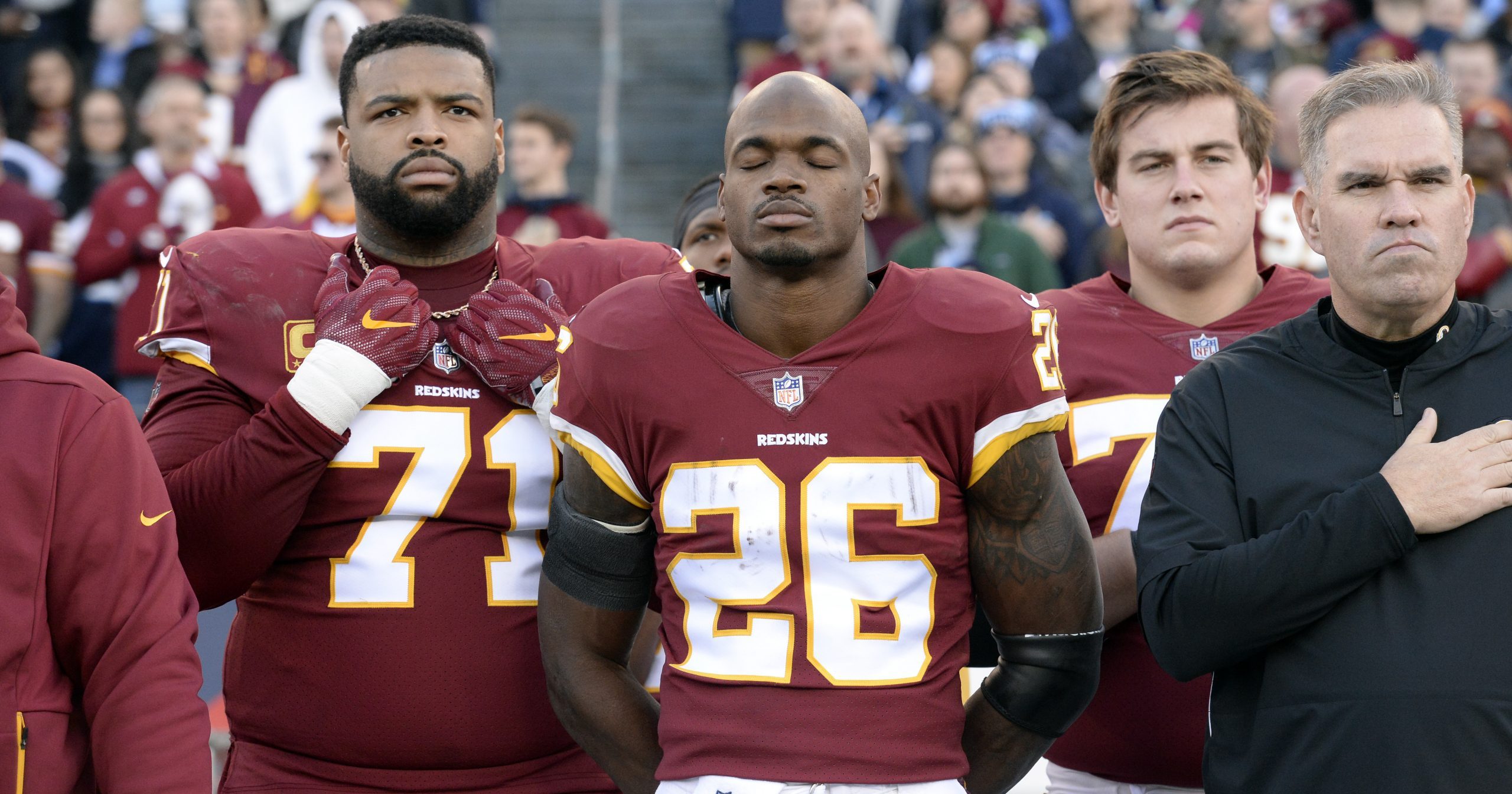 In this Dec. 22, 2018, file photo, Washington Redskins running back Adrian Peterson (26) stands for the national anthem before an NFL football game against the Tennessee Titans in Nashville.