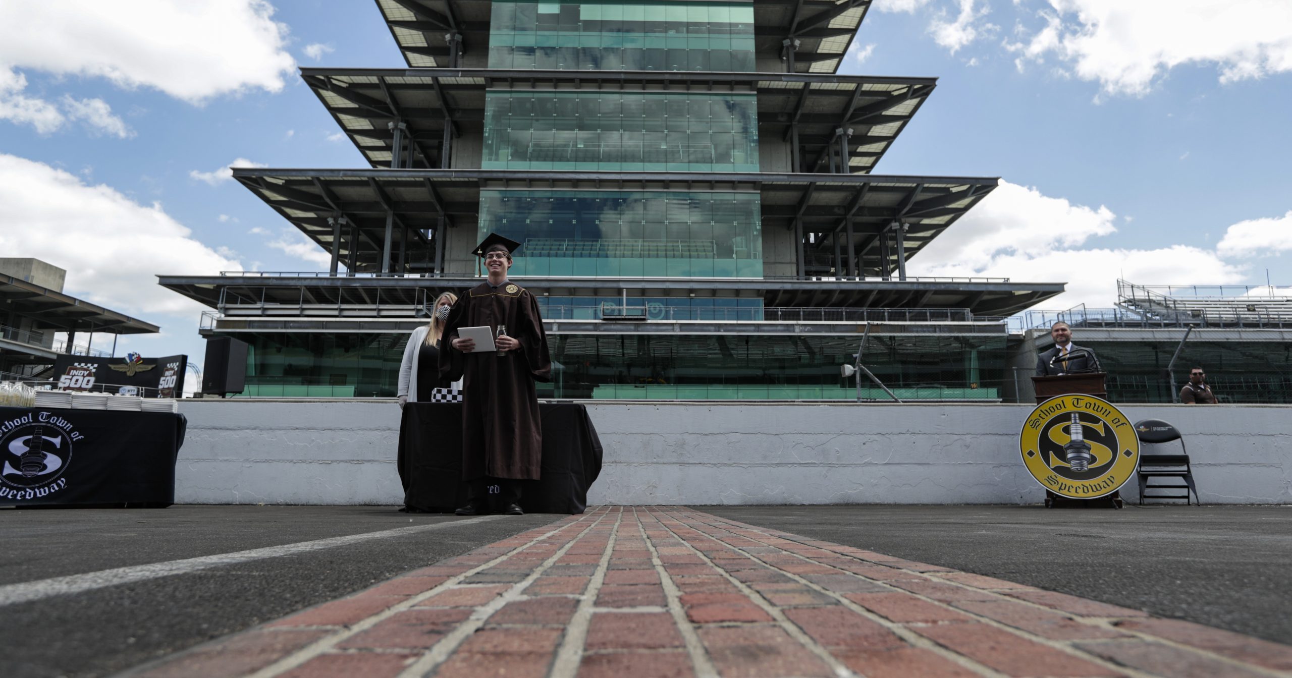 Eli Collins receives his Speedway High School diploma during a ceremony on the start/finish line at the Indianapolis Motor Speedway in Indianapolis on May 30, 2020. The ceremony was held at the track to allow for social distancing requirements due to the coronavirus pandemic.