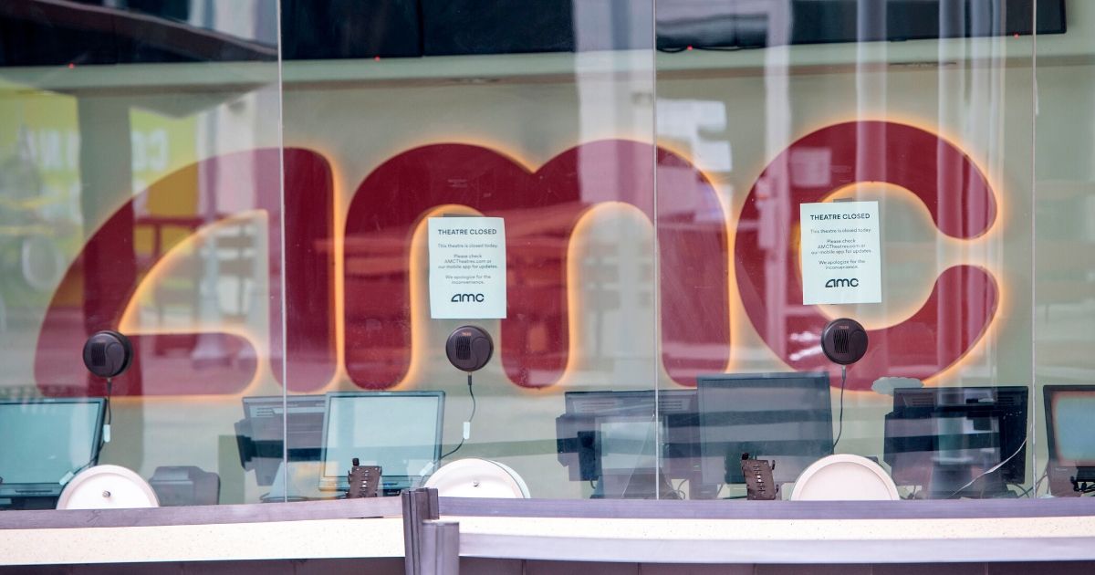 Signs on the window of an AMC theater in Burbank, California, say it's closed during the coronavirus pandemic on May 12, 2020.