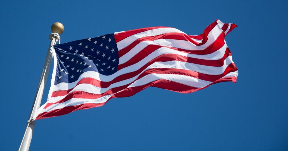 An American flag flies on a flagpole.