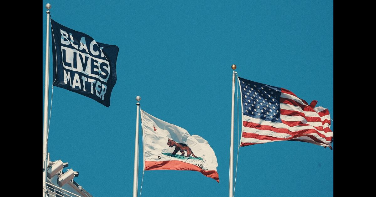 A Black Lives Matter flag flies alongside the California state flag and American flag at Levi's Stadium in Santa Clara, home of the San Francisco 49ers.