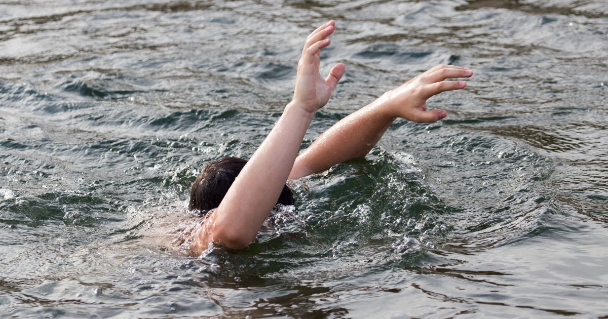 Stock image of a person struggling in the water. A man in his 60s lost his life this week when he jumped into a fast river to help save a young child from drowning.