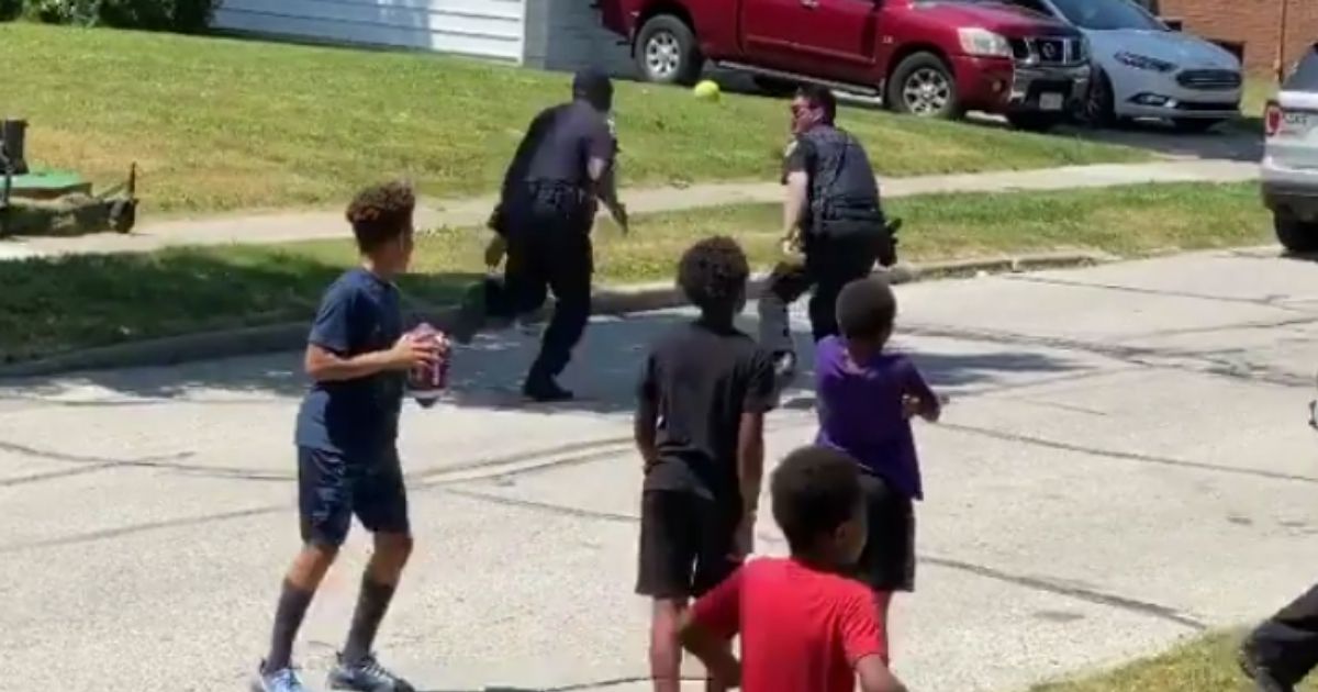 A pair of Ohio policemen had the perfect response after they were called in to stop some kids from playing football in the streets: They joined in.