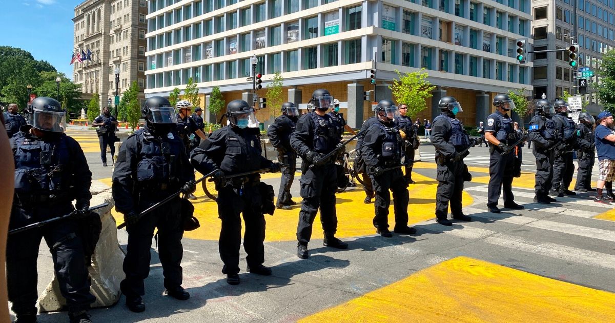 A row of police officers stand at Black Lives Matter Plaza near H Street, NW, in Washington, D.C. on June 23, 2020.
