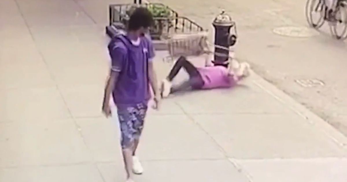 An elderly woman is knocked down by a young man in New York.