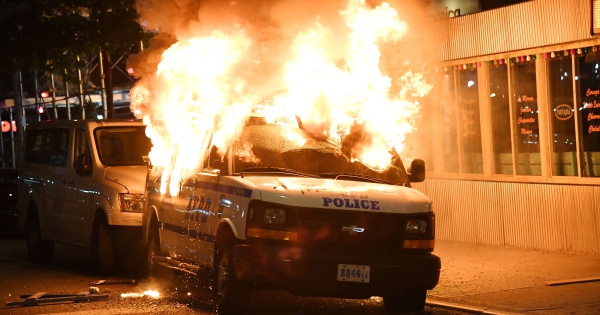 FDNY firefighters work to put out fires on NYPD vehicles caused by rioters near Union Square on May 30, 2020, in New York City.