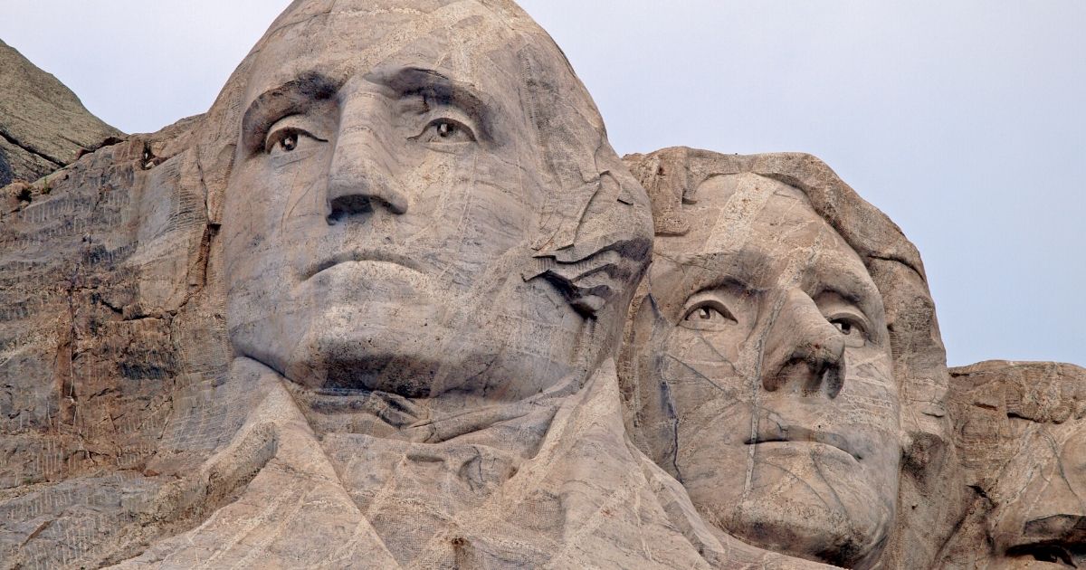 The sculpted images of George Washington, left, and Thomas Jefferson are seen above on Mount Rushmore.