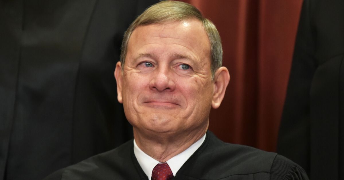 Chief Justice John Roberts poses for the official group photo at the U.S. Supreme Court in Washington on Nov. 30, 2018.