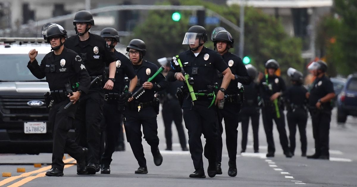 LAPD officers head toward a store being looted in Hollywood, California, on June 1, 2020.
