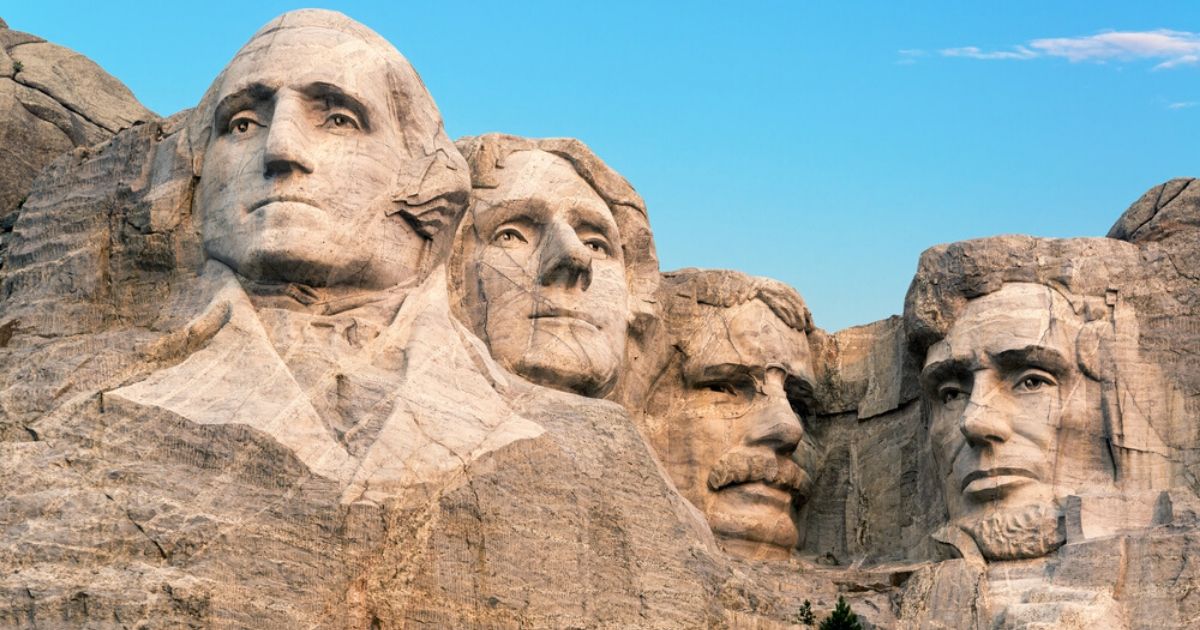 A stock photo of Mount Rushmore is seen above.