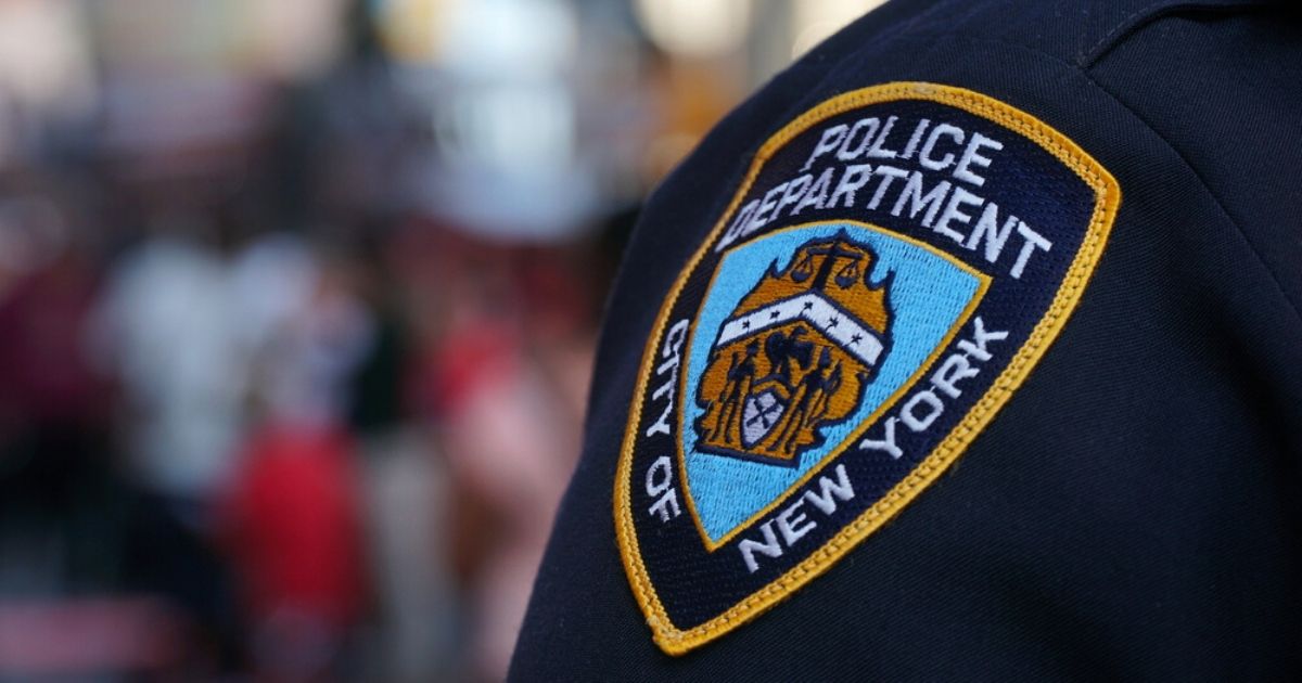 A stock photo of an NYPD badge is seen above.