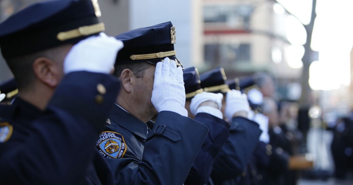 New York City Police Officers salute in the stock image above.
