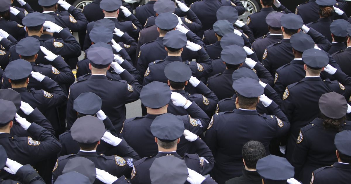 Police officers stand at attention in 2015 the image above.