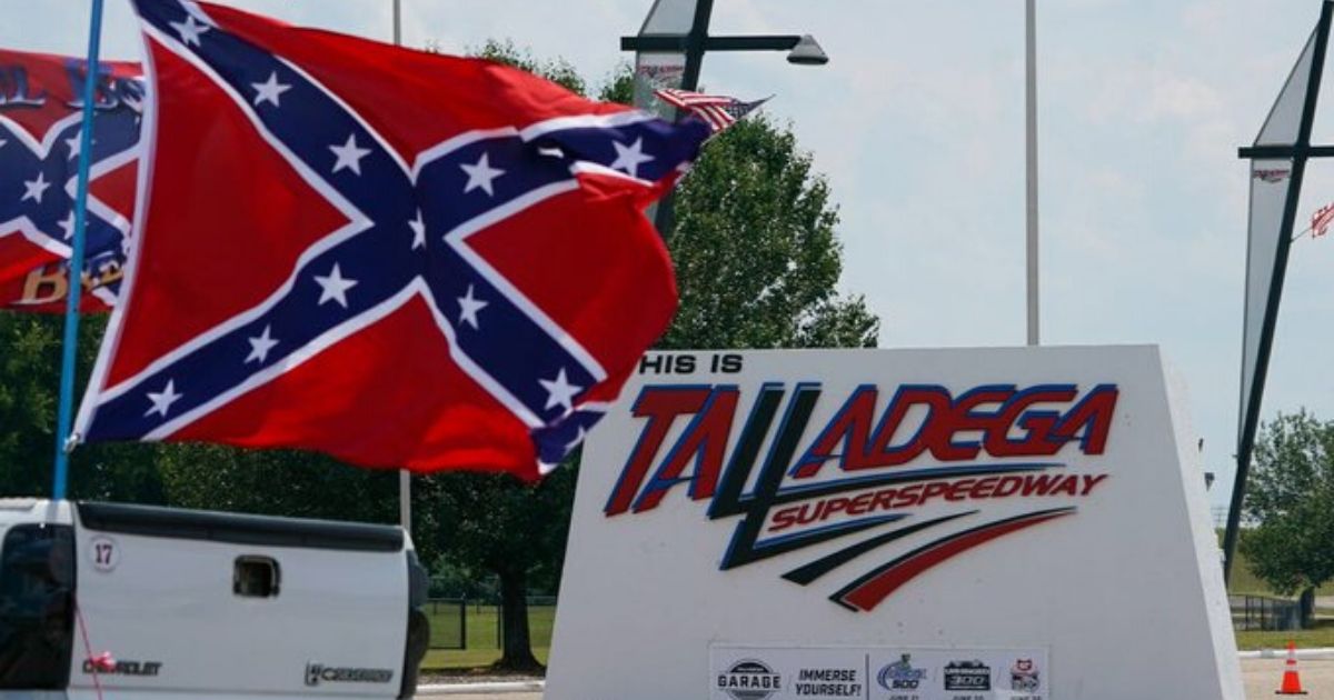 A truck flying a Confederate battle flag drives past Talladega Speedway.