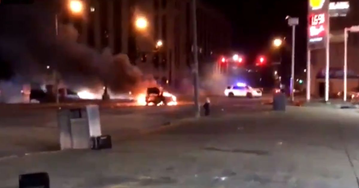 A vehicle is on fire during riots in St. Louis.
