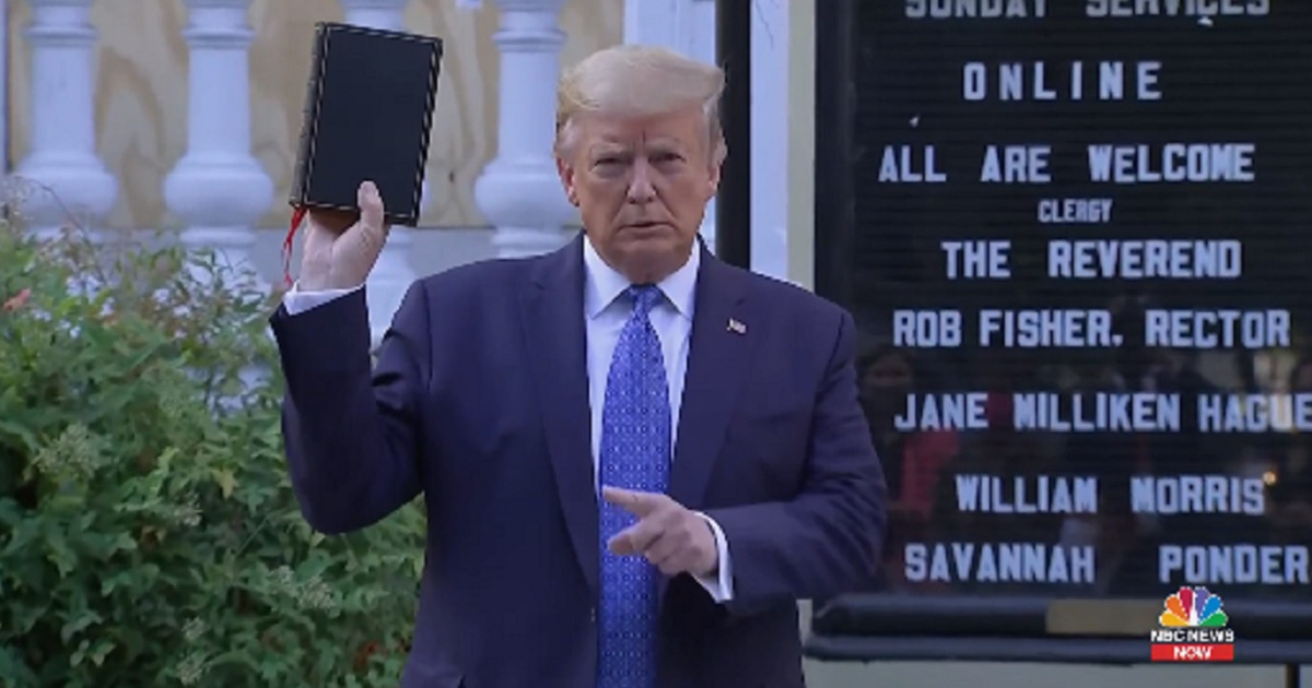 President Donald Trump holds a Bible aloft outside St. John's Episcopal Church in Washington on Monday.