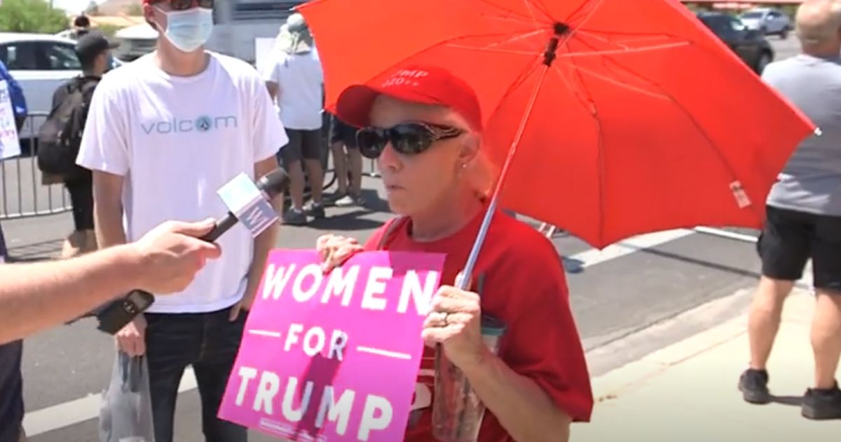 A woman shows support for President Donald Trump during his rally in Phoenix.