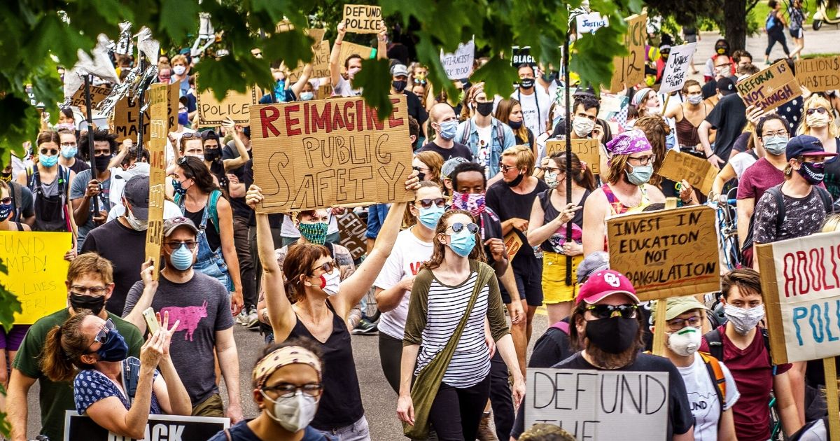 Demonstrators march to defund the Minneapolis Police Department on June 6, 2020, in Minneapolis.