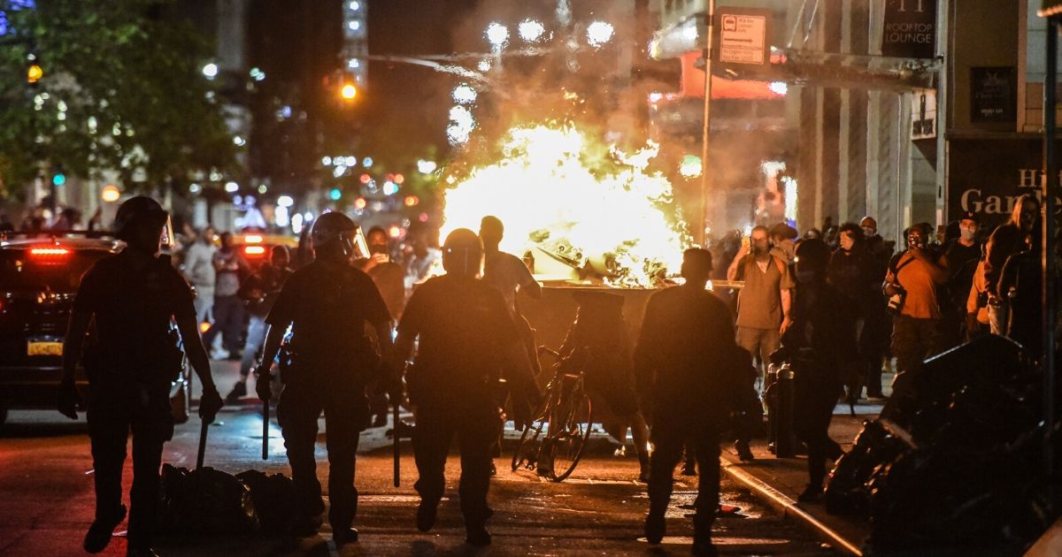 Rioters set a dumpster on fire on May 31, 2020, in New York City.