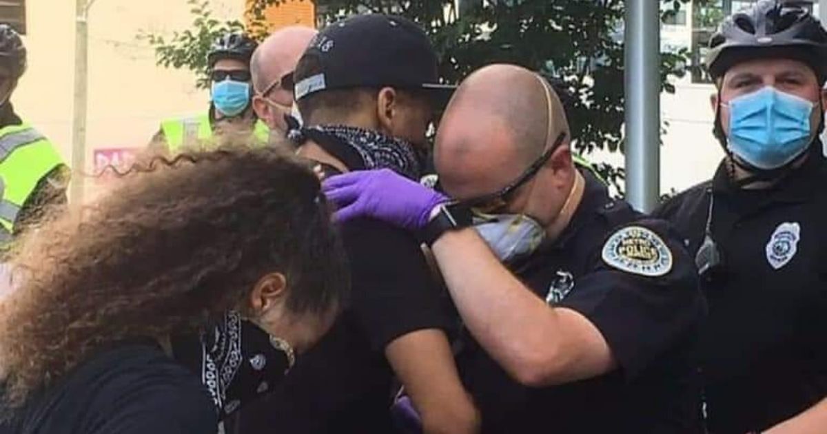 A police officer and protester pray together in Nashville, Tennessee.