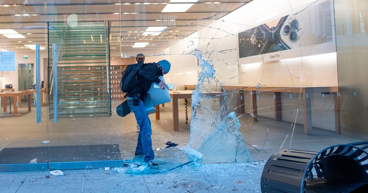 An Apple store in the Fairfax District of Los Angeles is struck by looters during a May 30 outburst of violence stemming from the death of a Minnesota man in police custody.