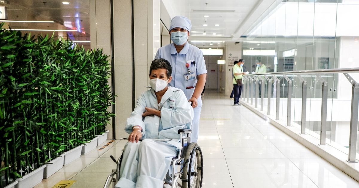 A nurse helps a patient in a hospital on June 8, 2020, in Beijing.