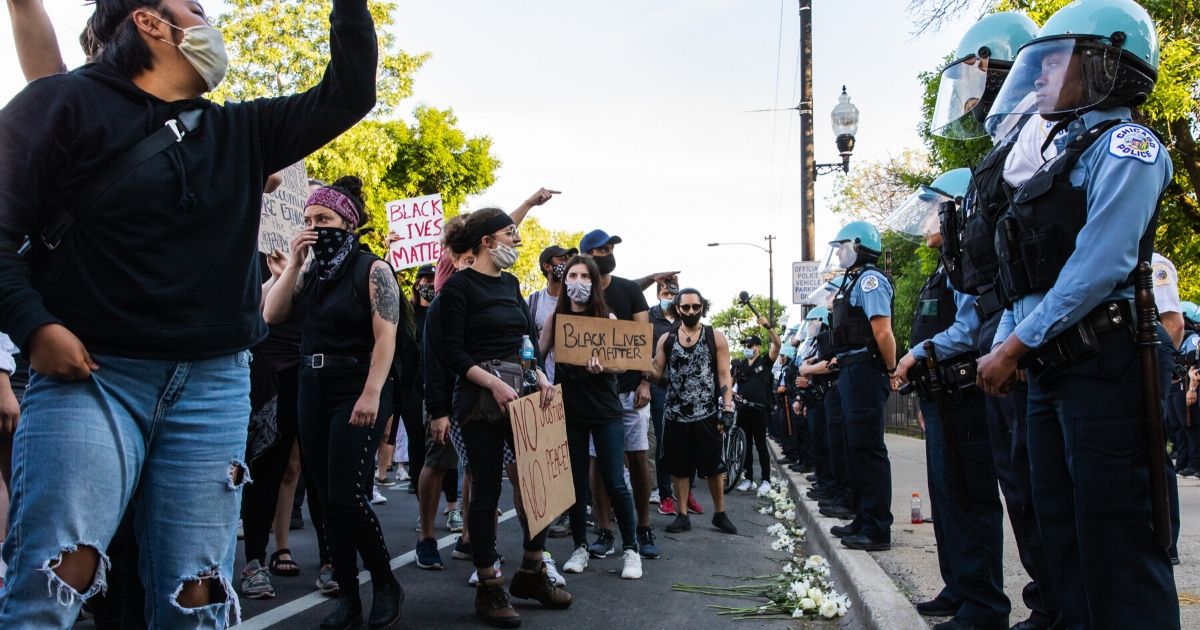 Protesters chant and wave signs at police during a protest on June 6, 2020, in Chicago.