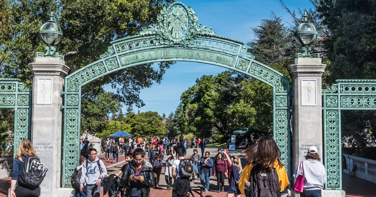 Students pass through Sather Gate, a landmark built in 1910, connecting Sproul Plaza to the center of the college campus at the University of California, Berkeley.