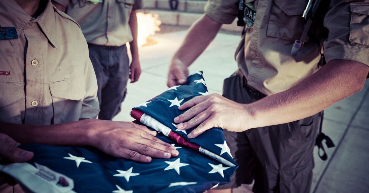 Boy Scouts fold an American flag during a ceremony at a Colorado camp in an undated file photo.