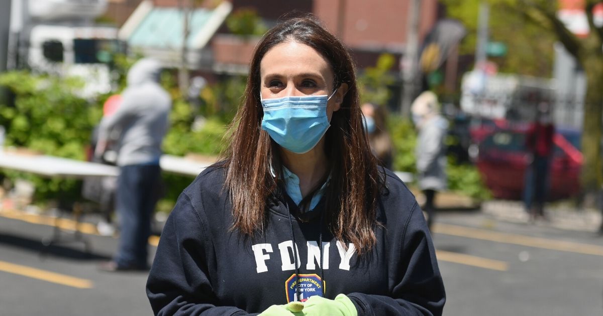 Michelle Caruso-Cabrera, a Democratic challenger to Rep. Alexandria Ocasio-Cortez in New York 14th Congressional District, hands out face masks at St. Mark AME Church in the Queens borough of New York City on May, 12, 2020.