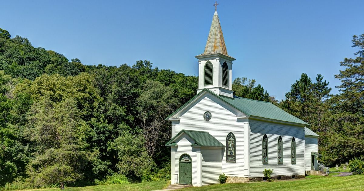 Stock image of a rural country church in a forest.