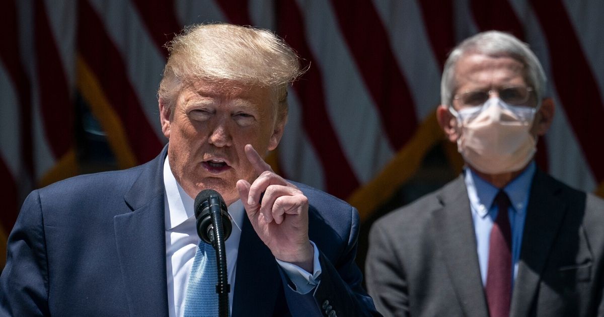 Dr. Anthony Fauci, right, the director of the National Institute of Allergy and Infectious Diseases, looks on as President Donald Trump delivers remarks about coronavirus vaccine development in the Rose Garden of the White House on May 15, 2020, in Washington, D.C.