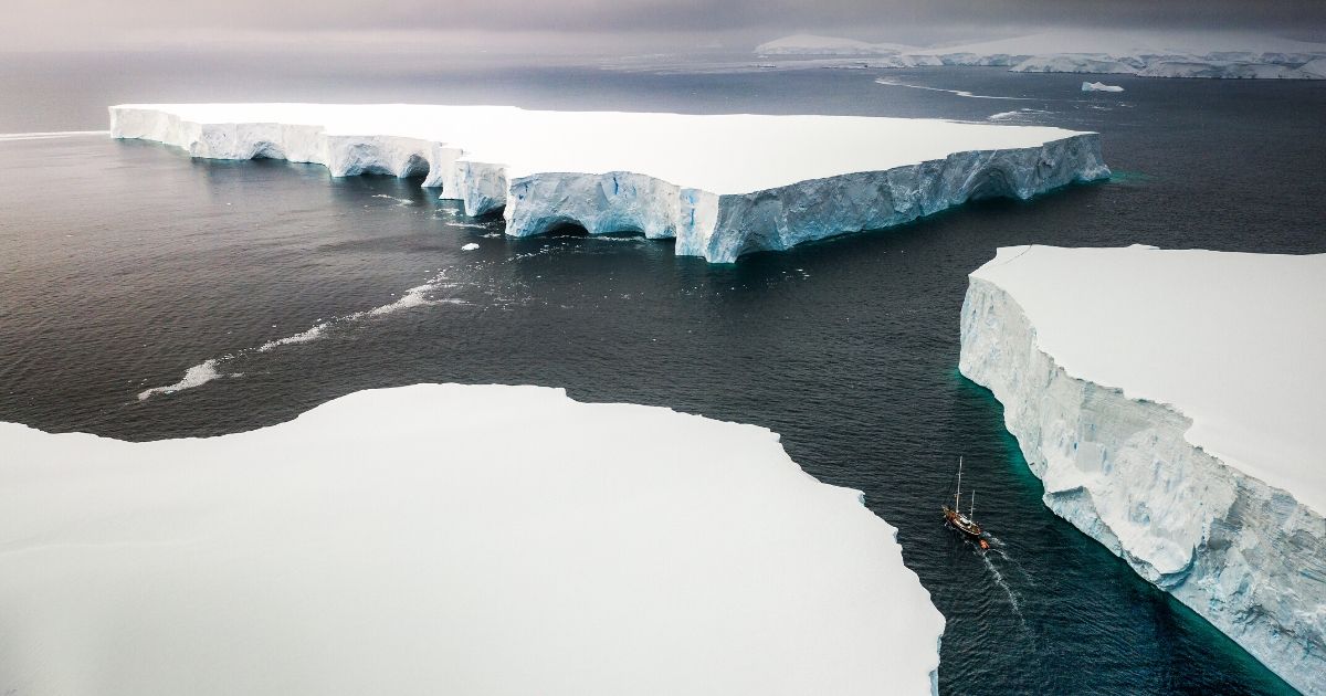 A ship sails through enormous icebergs near the Melchior islands in Antarctica.