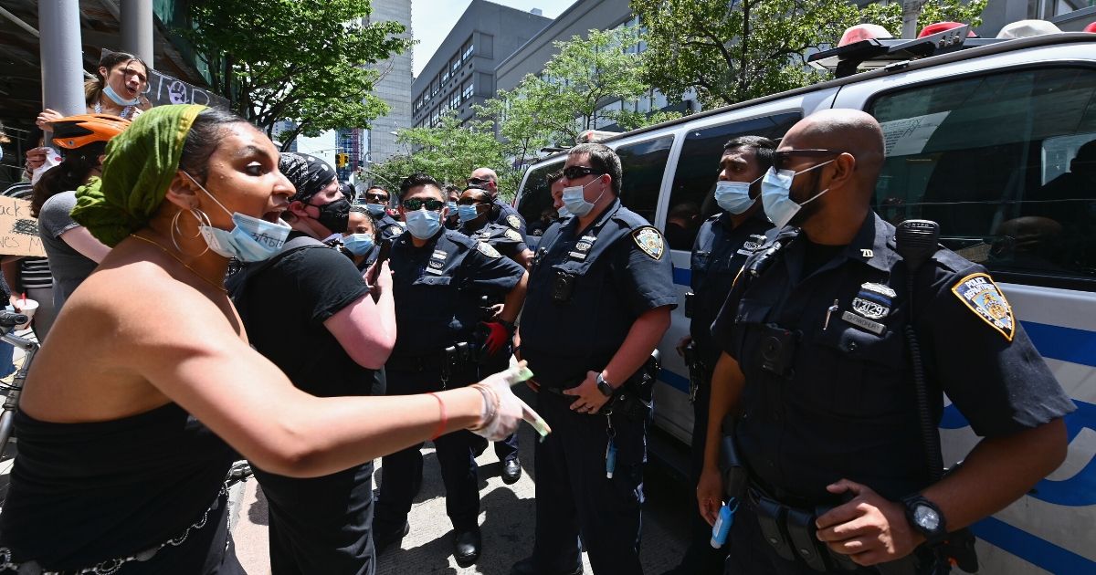 Protesters face off with police during a "Black Trans Lives Matter" march on June 17, 2020, in the Brooklyn Borough of New York City.