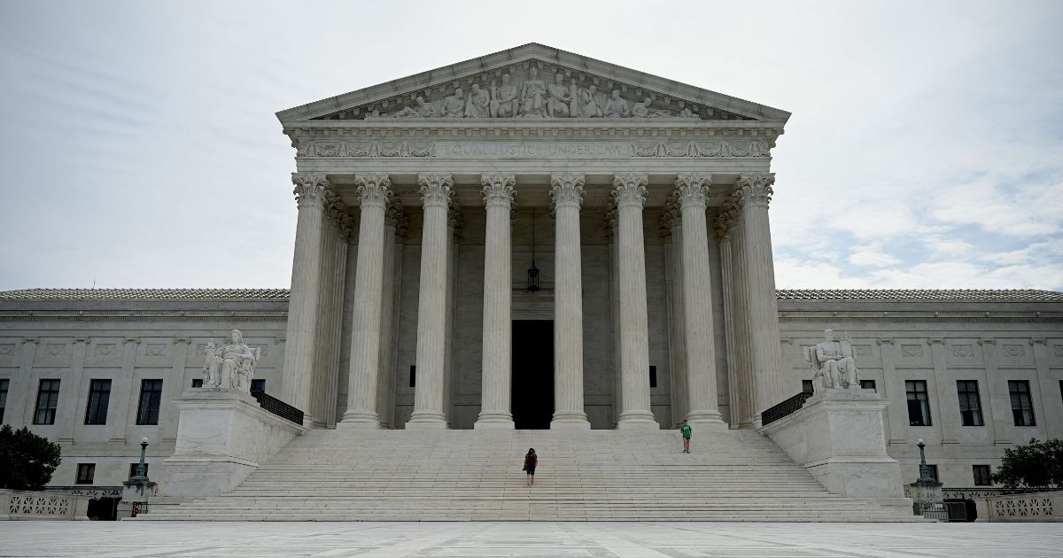 A woman walks down the steps of the U.S. Supreme Court on June 15, 2020, in Washington, D.C.