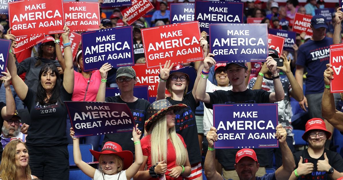 Supporters hold up signs during a campaign rally for President Donald Trump at the BOK Center on June 20, 2020, in Tulsa, Oklahoma.