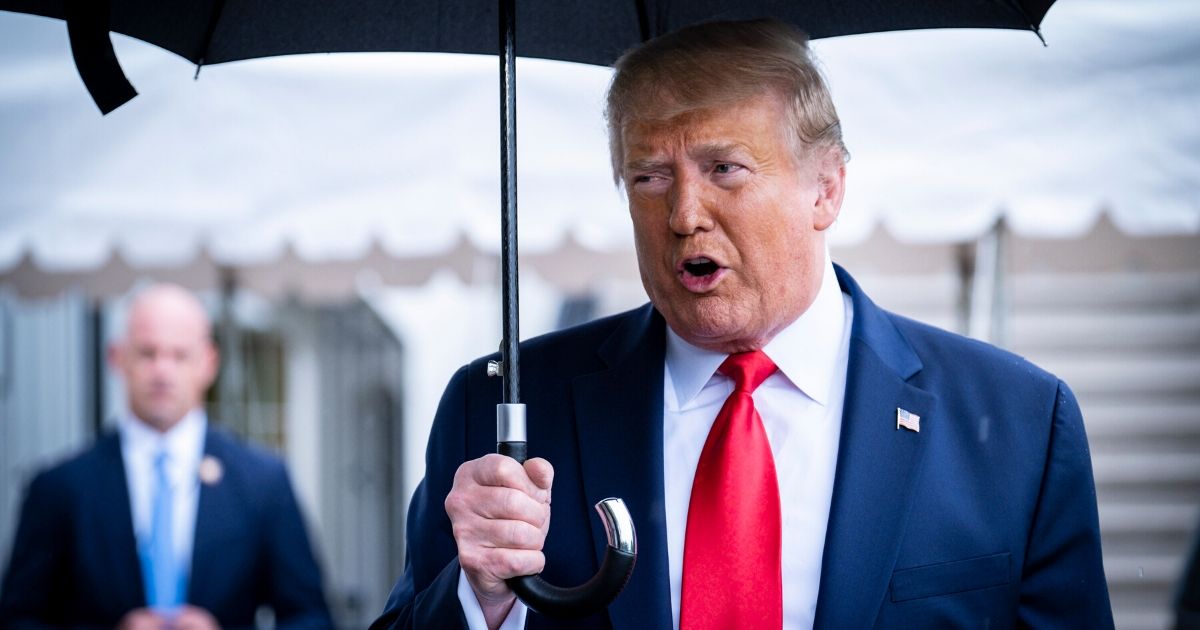 President Donald Trump stops to speak to the media in the rain on the South Lawn of the White House as he prepares to depart aboard Marine One for a rally in Tulsa, Oklahoma, on June 20, 2020, in Washington, D.C.