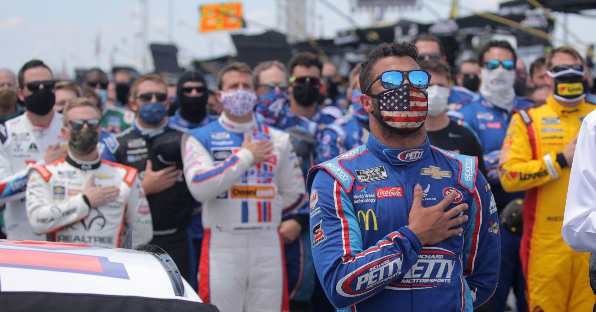 Bubba Wallace, driver of the #43 Victory Junction Chevrolet, stands for the national anthem prior to the NASCAR Cup Series GEICO 500 at Talladega Superspeedway on June 22, 2020 in Talladega, Alabama.