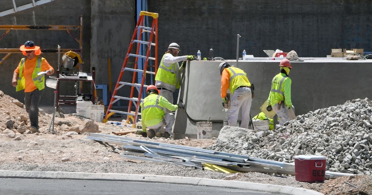 Construction crews work on the base of the Al Davis memorial torch at the entrance of the 336,000-square-foot Las Vegas Raiders Headquarter under construction on June 10, 2020, in Henderson, Nevada.