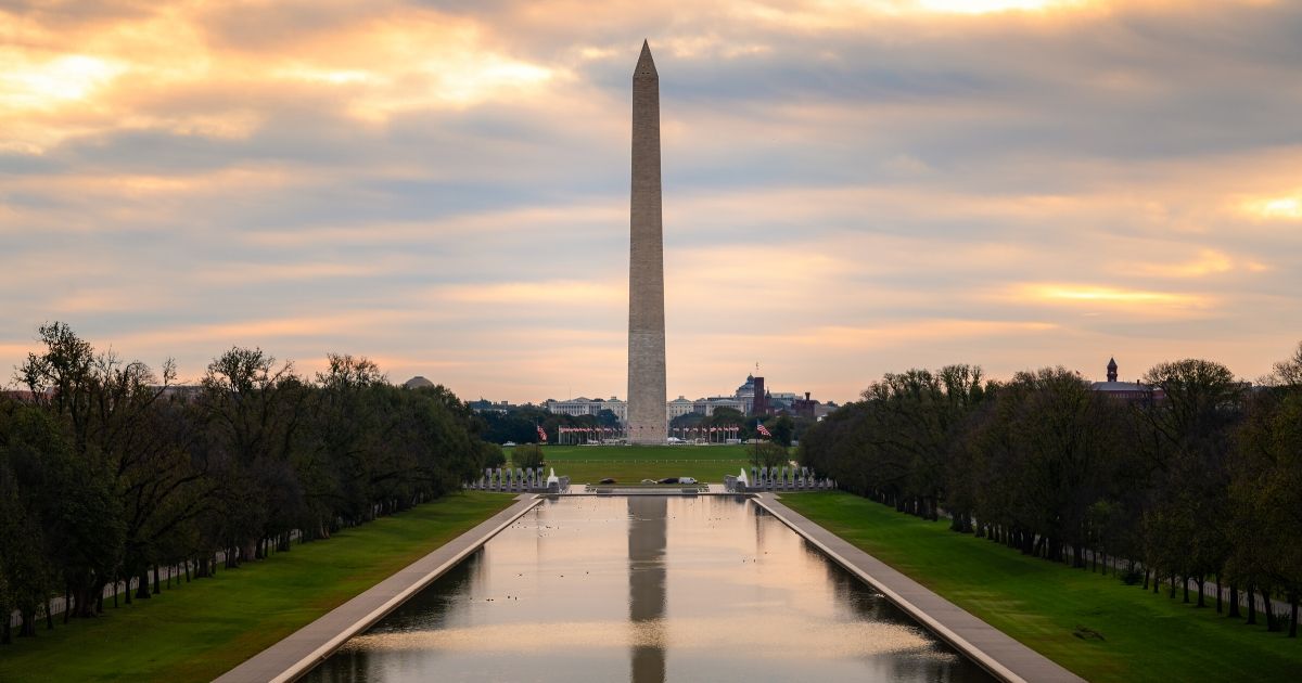 The Washington Monument and the Reflecting Pool in Washington, D.C., at dawn.