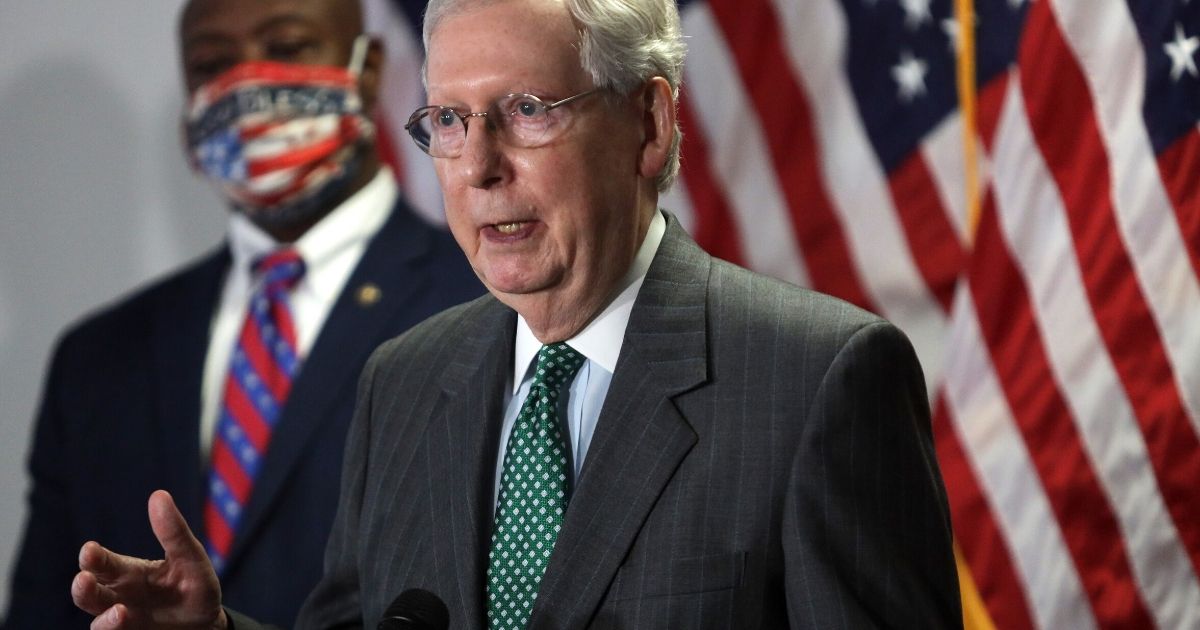 Senate Majority Leader Mitch McConnell speaks to members of the media as Sen. Tim Scott of South Carolina looks on following the weekly Senate Republican Policy Luncheon at the Hart Senate Office Building June 23, 2020, on Capitol Hill in Washington, D.C.