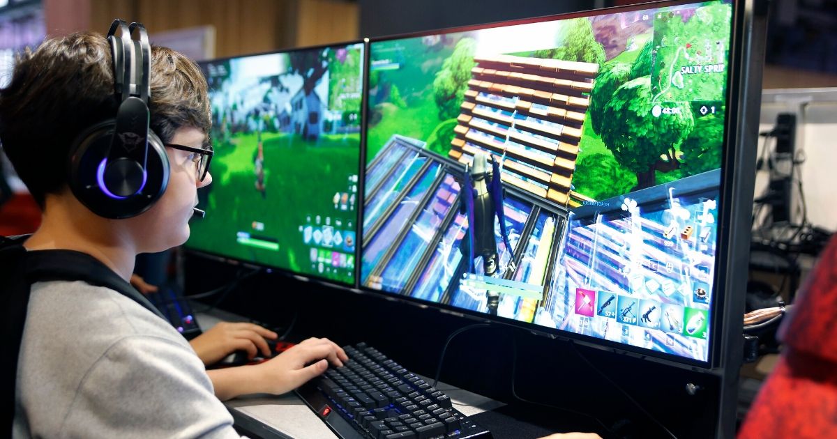 A gamer plays the video game "Fortnite Battle Royale" developed by Epic Games in a file photo from Paris Games Week in October 2018.