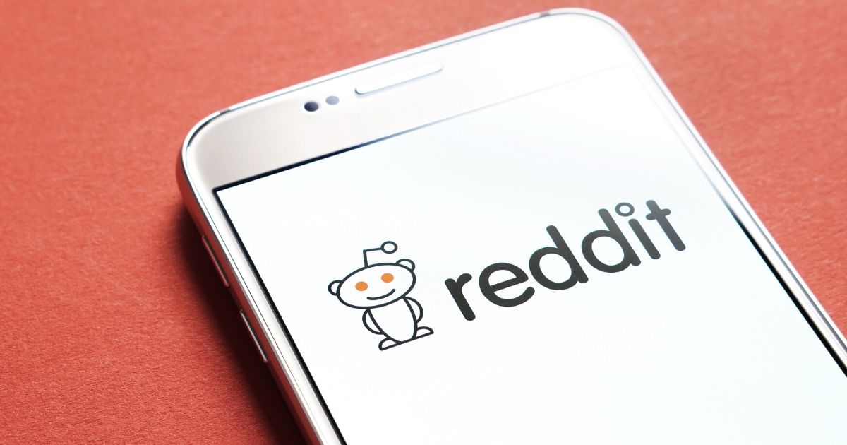Stock image of the Reddit logo on a smartphone screen.