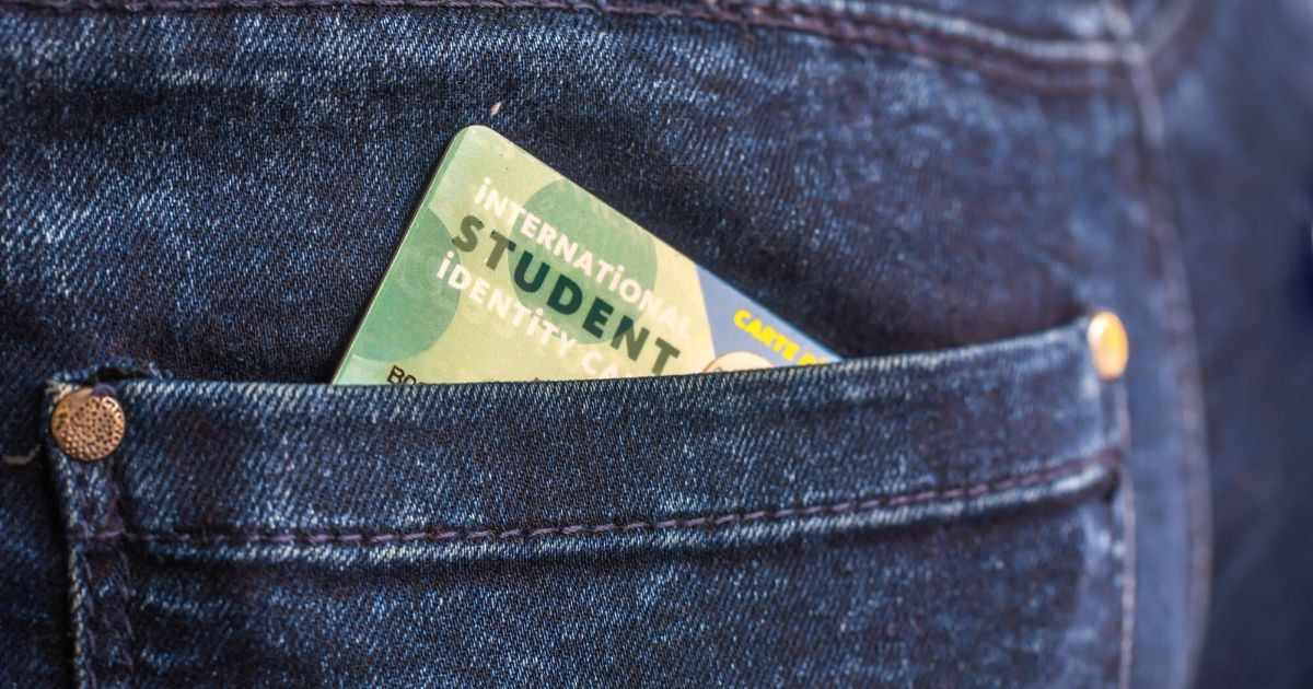 A student ID card in a jeans pocket.