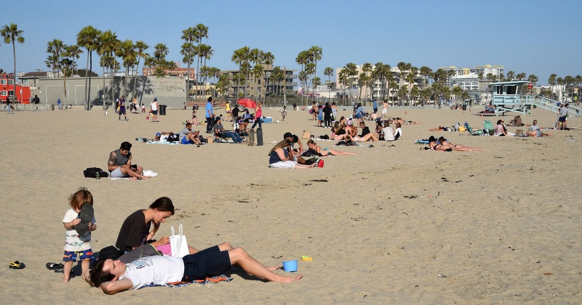 People enjoy the sunshine at Venice Beach in Los Angeles on June 6, 2020.