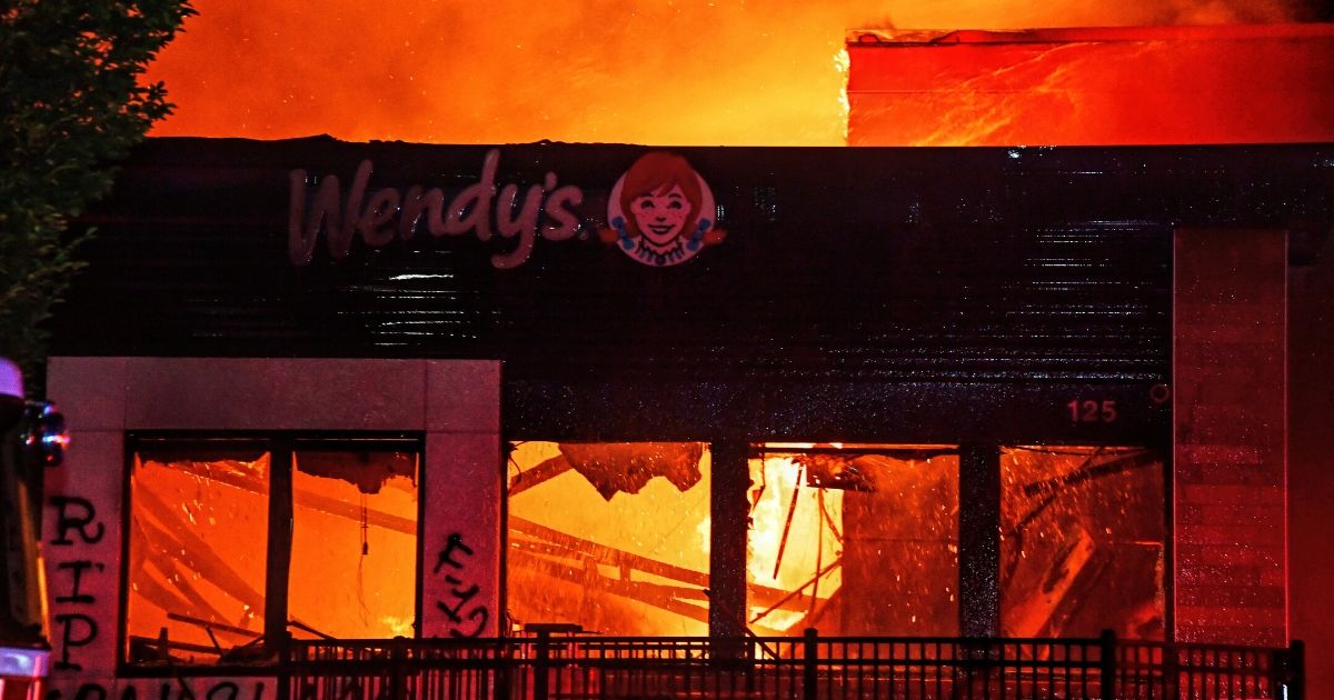 A Wendy's in Atlanta burns after protesters set it on fire following the death of Rayshard Brooks outside the restaurant on June 13, 2020.