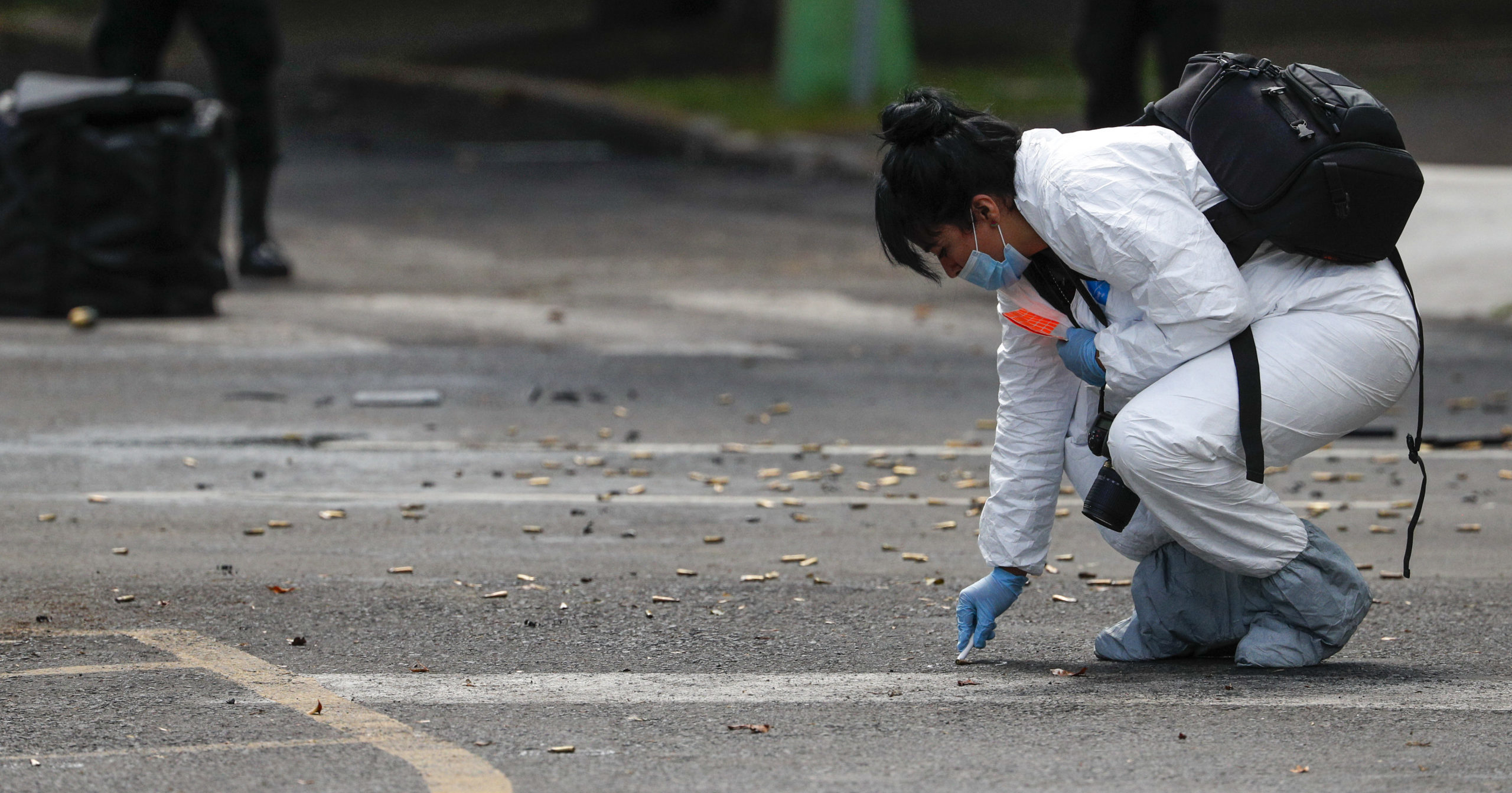 A forensic investigator collects cartridges at the scene where Mexico City's police chief was attacked by gunmen on June 26, 2020. Heavily armed gunmen attacked and wounded Omar García Harfuch in an operation that left three dead.